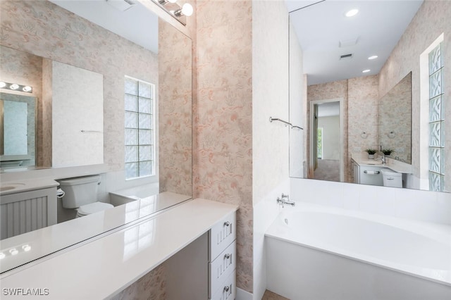 8511 Alessandria Ct, Naples, FL 34114 - full bath with a bath, wallpapered walls, toilet, and vanity