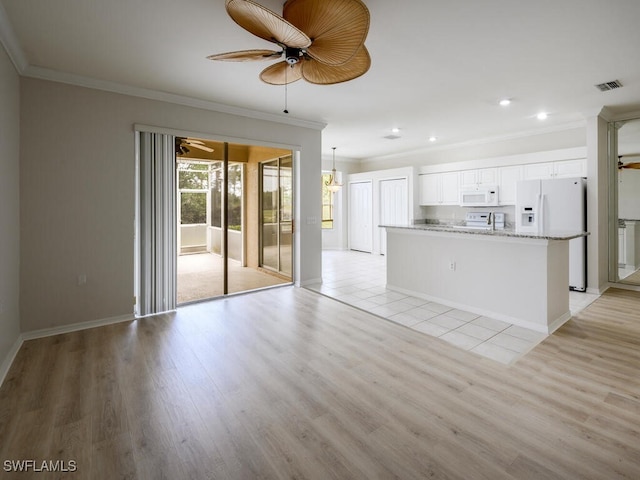 unfurnished living room featuring visible vents, baseboards, ceiling fan, ornamental molding, and light wood-type flooring