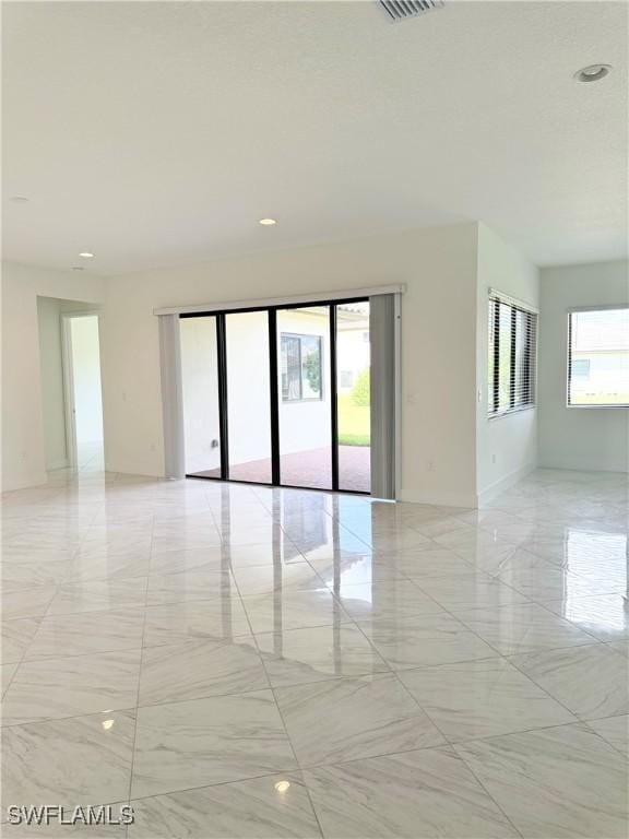 5048 Gambero Way, Ave Maria, FL 34142 - spare room featuring recessed lighting, visible vents, marble finish floor, and baseboards