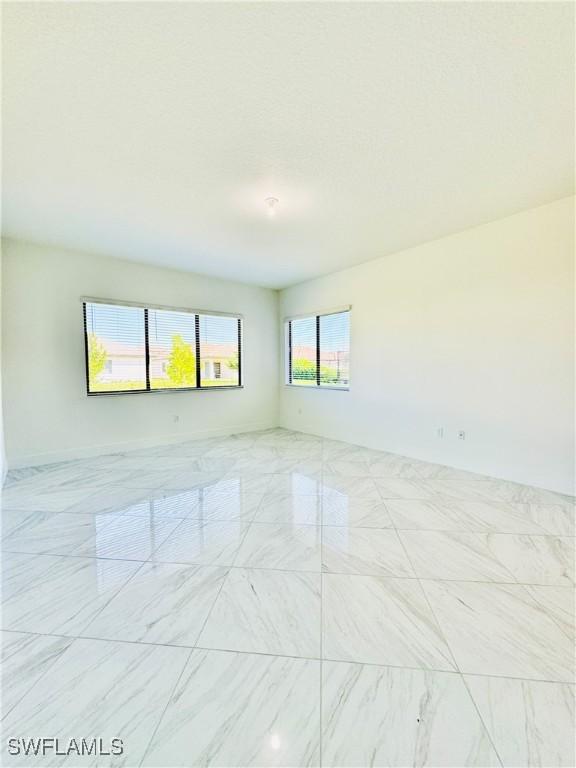 5048 Gambero Way, Ave Maria, FL 34142 - spare room with marble finish floor
