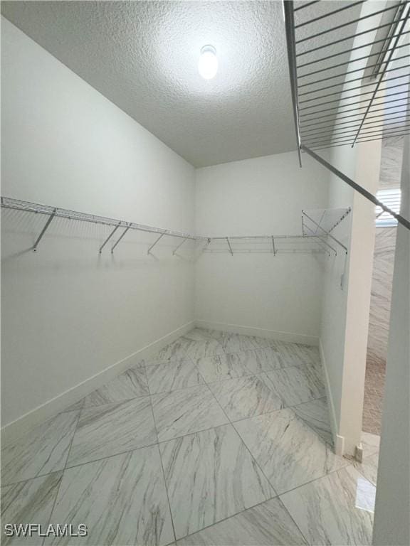 5048 Gambero Way, Ave Maria, FL 34142 - walk in closet featuring marble finish floor