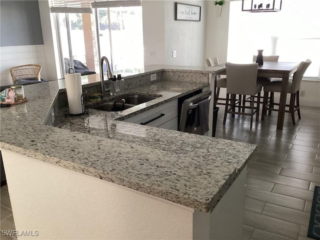 2939 Orange Grove Trl, Naples, FL 34120 - kitchen featuring a sink, dishwasher, light stone countertops, and plenty of natural light
