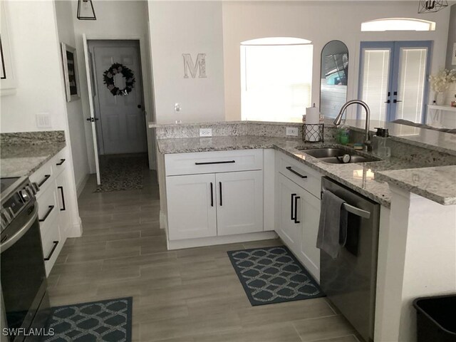 2939 Orange Grove Trl, Naples, FL 34120 - kitchen featuring a sink, stainless steel dishwasher, electric range oven, white cabinetry, and light stone counters