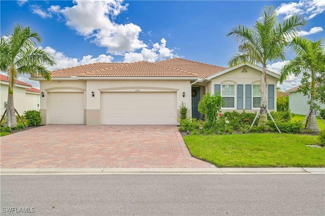 2916 Royal Gardens Ave, Fort Myers, FL 33916 - single story home featuring stucco siding, decorative driveway, an attached garage, and a tile roof