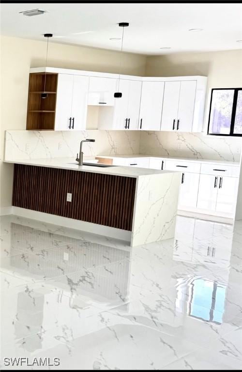 4800 Nora Ave N, Lehigh Acres, FL 33971 - kitchen with backsplash, open shelves, light marble finish flooring, and white cabinetry