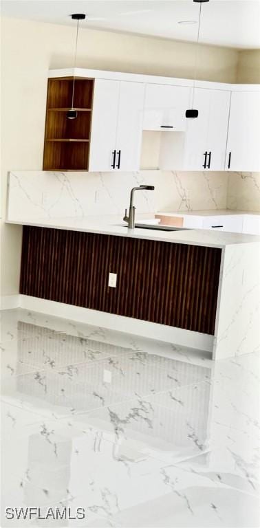 4800 Nora Ave N, Lehigh Acres, FL 33971 - kitchen with white cabinets, decorative backsplash, open shelves, and pendant lighting