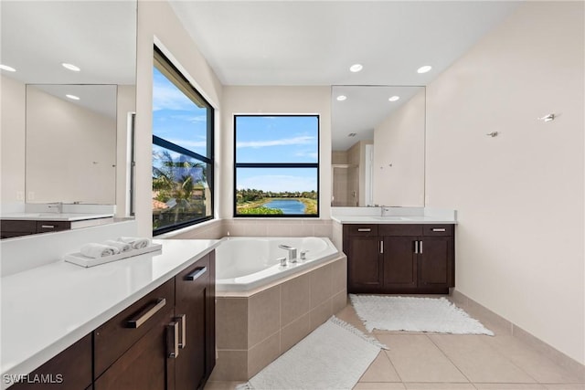 full bathroom with tile patterned flooring, a shower stall, a sink, two vanities, and a bath