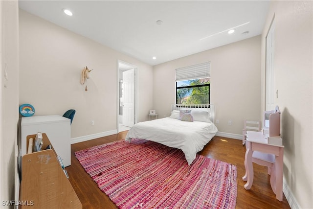 bedroom featuring baseboards, wood finished floors, and recessed lighting