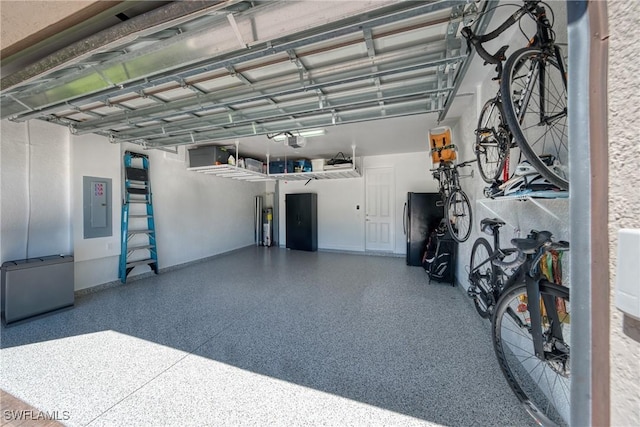 garage with electric panel, a garage door opener, and freestanding refrigerator
