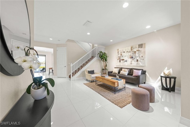 tiled living room featuring visible vents, baseboards, stairway, and recessed lighting