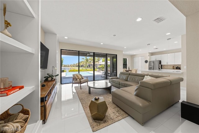 living area with light tile patterned floors, recessed lighting, and visible vents