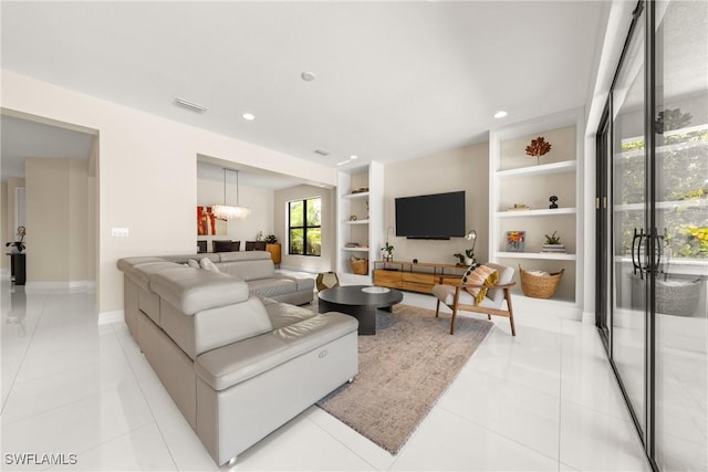 living area with recessed lighting, light tile patterned floors, baseboards, visible vents, and built in features