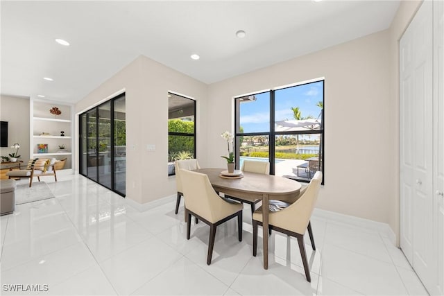 dining space with baseboards, built in shelves, recessed lighting, and light tile patterned floors