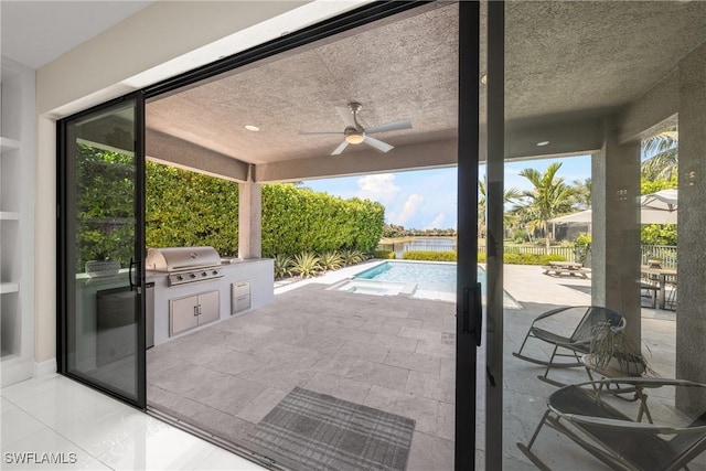 view of patio / terrace with fence, exterior kitchen, grilling area, an outdoor pool, and ceiling fan
