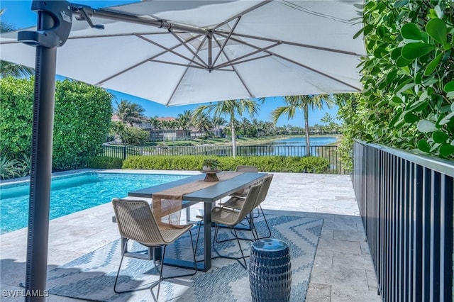 view of pool featuring a water view, fence, a patio, outdoor dining area, and a fenced in pool