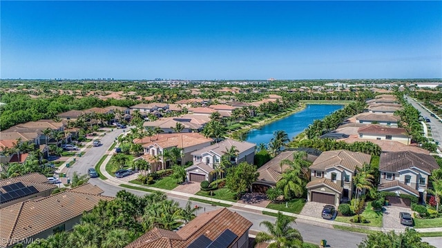 birds eye view of property with a water view and a residential view