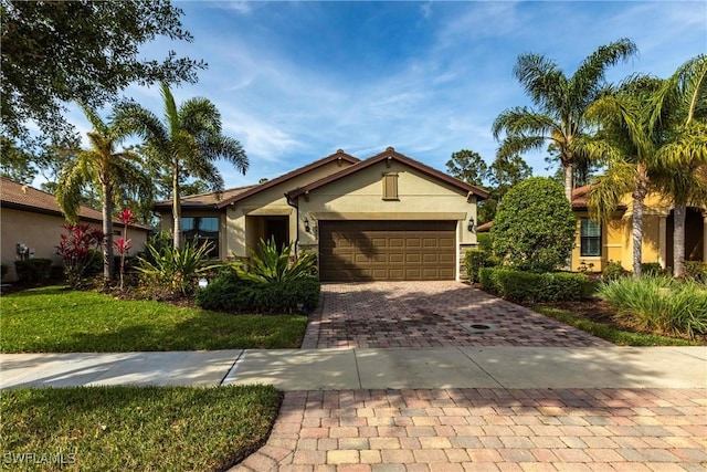 10870 Maitland Way, Fort Myers, FL 33913 - single story home with stucco siding, decorative driveway, and an attached garage