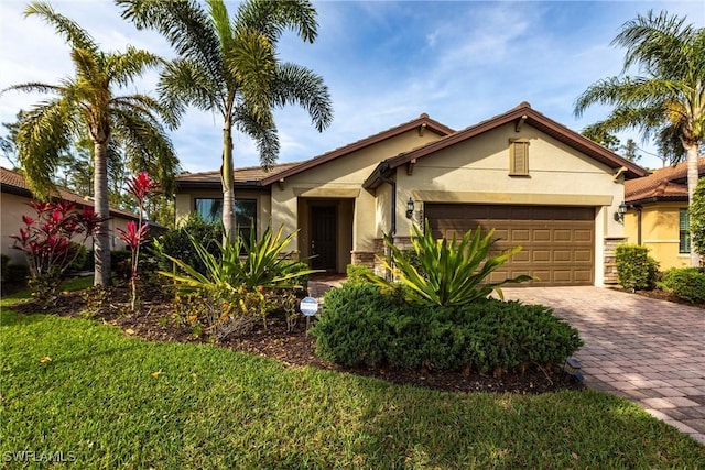 10870 Maitland Way, Fort Myers, FL 33913 - ranch-style home with stucco siding, an attached garage, decorative driveway, and a front yard