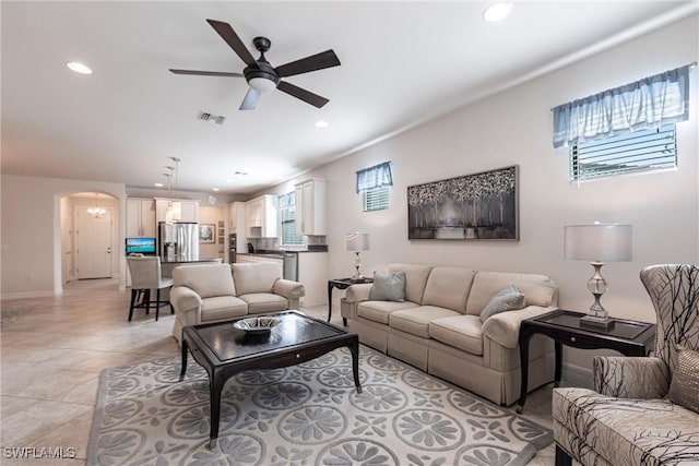 10870 Maitland Way, Fort Myers, FL 33913 - living room with arched walkways, ceiling fan, recessed lighting, baseboards, and light tile patterned flooring