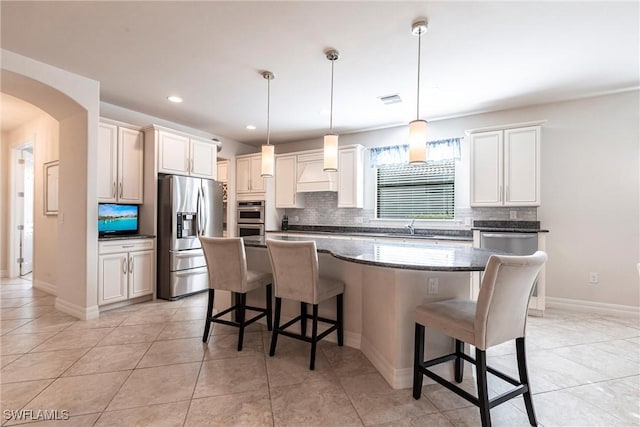 10870 Maitland Way, Fort Myers, FL 33913 - kitchen with stainless steel appliances, backsplash, a kitchen breakfast bar, a kitchen island, and recessed lighting