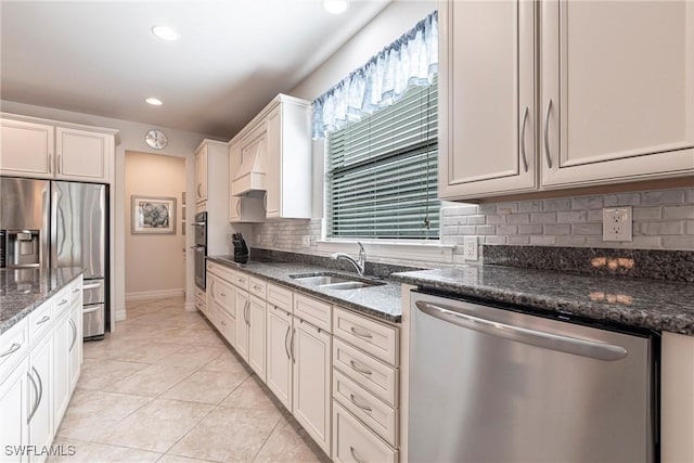10870 Maitland Way, Fort Myers, FL 33913 - kitchen with stainless steel appliances, a sink, decorative backsplash, dark stone countertops, and recessed lighting