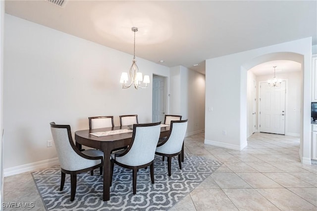 10870 Maitland Way, Fort Myers, FL 33913 - dining area with a chandelier, arched walkways, baseboards, and light tile patterned floors