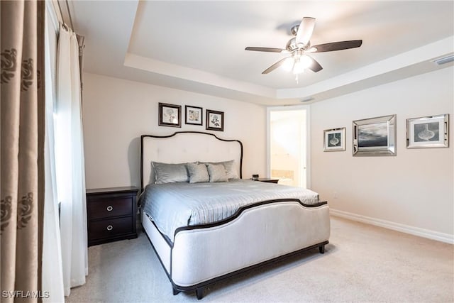 10870 Maitland Way, Fort Myers, FL 33913 - bedroom with a tray ceiling, baseboards, light carpet, and ensuite bathroom