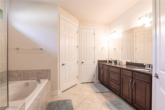 10870 Maitland Way, Fort Myers, FL 33913 - full bath with double vanity, a garden tub, tile patterned flooring, and baseboards