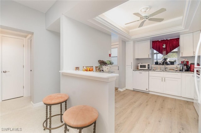 402 SE 42nd Ter Unit D 5, Cape Coral, FL 33904 - kitchen featuring white appliances, ornamental molding, white cabinetry, a sink, and a tray ceiling