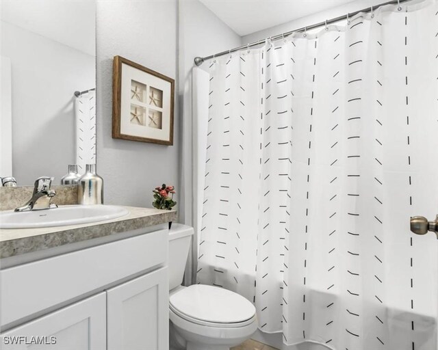 3002 69th St W, Lehigh Acres, FL 33971 - full bathroom featuring toilet, shower / bath combo with shower curtain, and vanity