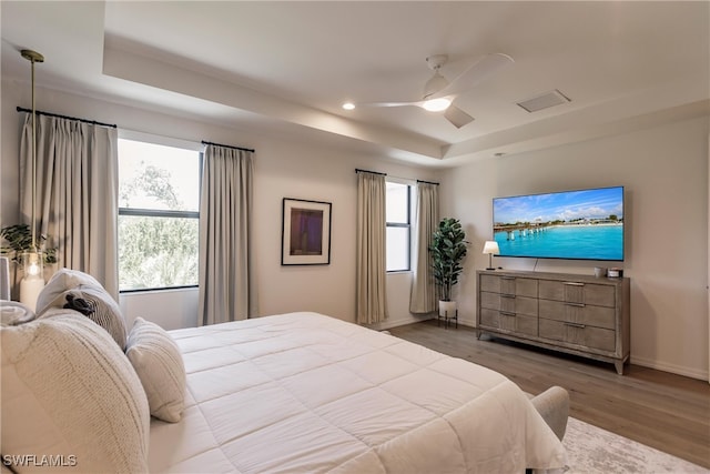 13005 Pembroke Dr, Naples, FL 34105 - bedroom with a tray ceiling, recessed lighting, baseboards, ceiling fan, and wood finished floors