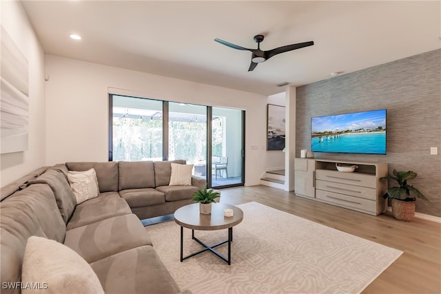 13005 Pembroke Dr, Naples, FL 34105 - living room with baseboards, ceiling fan, recessed lighting, light wood-style floors, and an accent wall