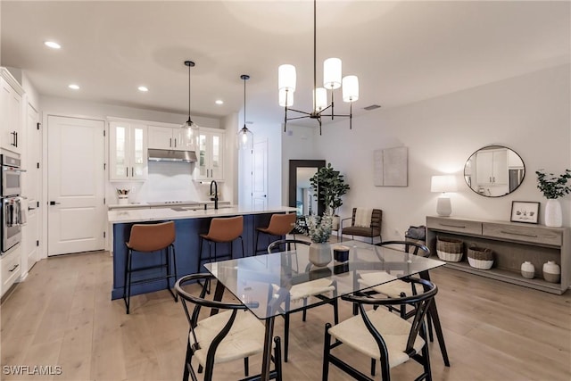 13005 Pembroke Dr, Naples, FL 34105 - dining area featuring a chandelier, visible vents, light wood finished floors, and recessed lighting