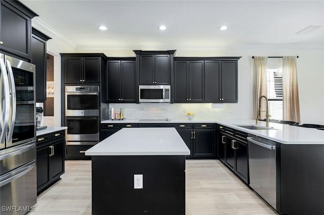 kitchen featuring a kitchen island, dark cabinets, and stainless steel appliances