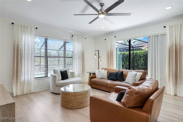 living room with light wood-style floors, ceiling fan, and recessed lighting