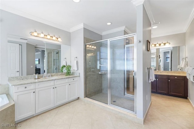 bathroom featuring tile patterned floors, a sink, a stall shower, and crown molding