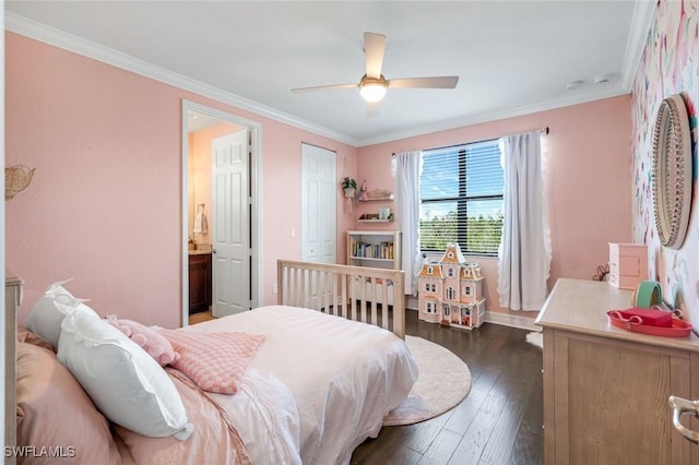 bedroom featuring crown molding, ensuite bathroom, baseboards, ceiling fan, and dark wood-style flooring
