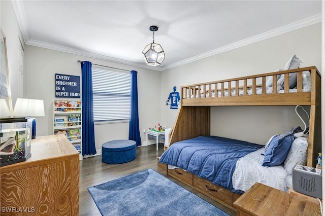 bedroom with crown molding, baseboards, and wood finished floors