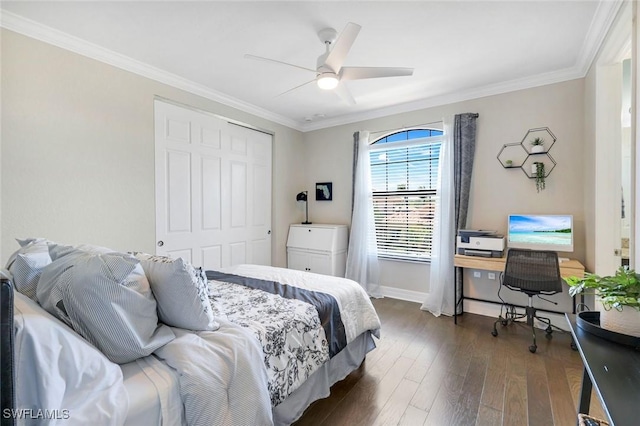 bedroom with dark wood-style floors, a closet, baseboards, and ornamental molding