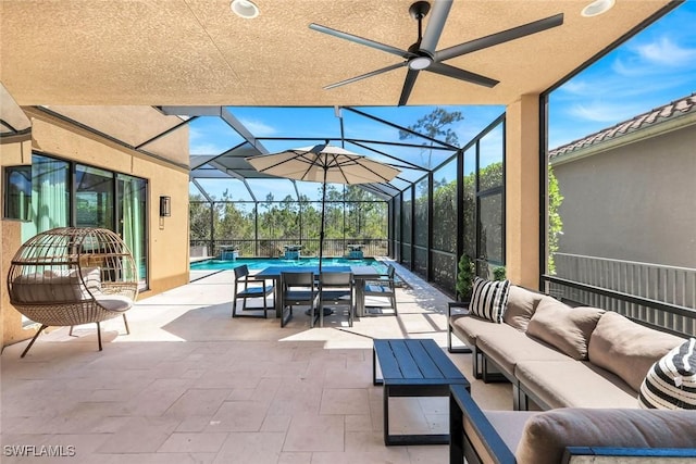 view of patio / terrace with an outdoor hangout area, an outdoor pool, a ceiling fan, and glass enclosure