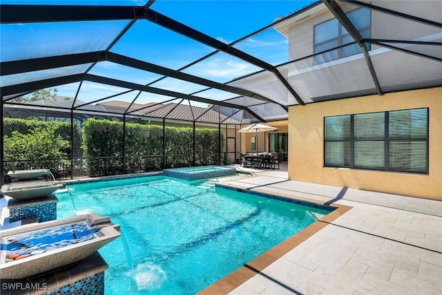 view of pool with glass enclosure, a pool with connected hot tub, and a patio area