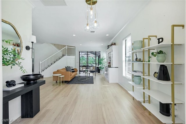 corridor featuring crown molding, stairway, recessed lighting, light wood-style floors, and visible vents