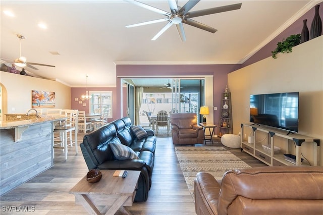 931 SW 35th Ter, Cape Coral, FL 33914 - living room featuring ceiling fan with notable chandelier, lofted ceiling, and a healthy amount of sunlight