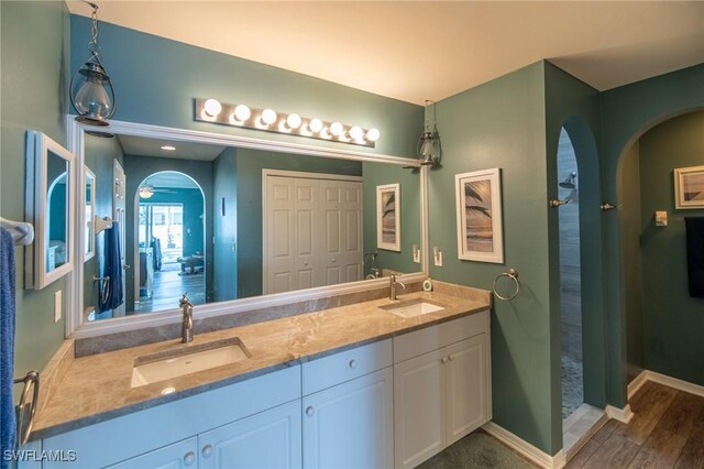 931 SW 35th Ter, Cape Coral, FL 33914 - full bath featuring baseboards, double vanity, and a sink