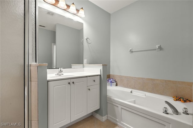 bathroom featuring visible vents, a garden tub, tile patterned floors, and vanity