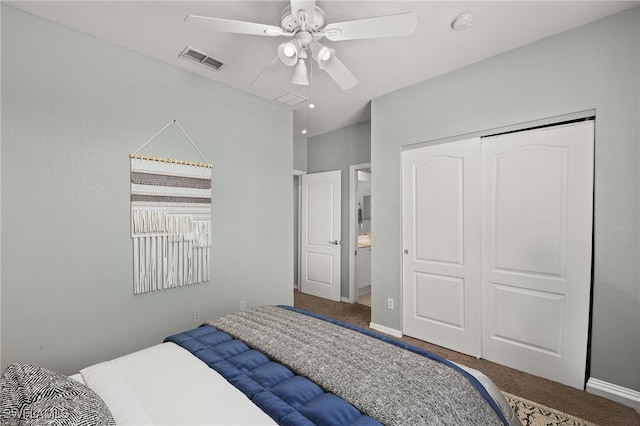 carpeted bedroom featuring baseboards, visible vents, a closet, and ceiling fan