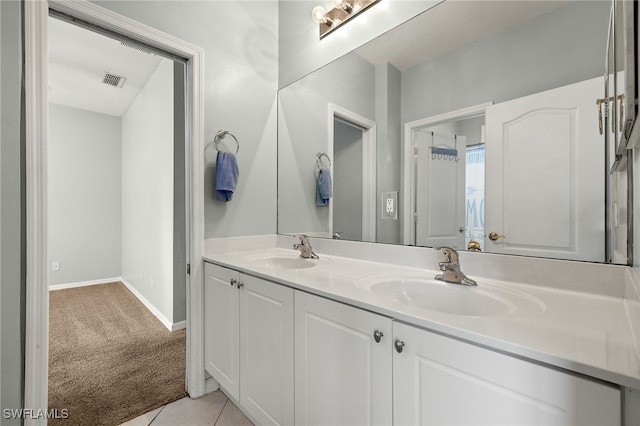 bathroom featuring double vanity, visible vents, a sink, and tile patterned floors