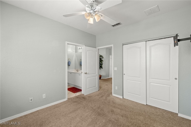 unfurnished bedroom featuring a closet, carpet floors, visible vents, and baseboards