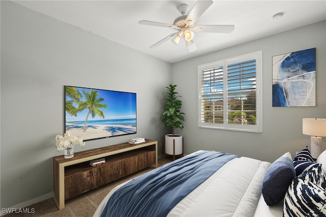 carpeted bedroom with baseboards and a ceiling fan