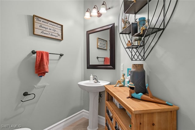 half bath featuring baseboards
